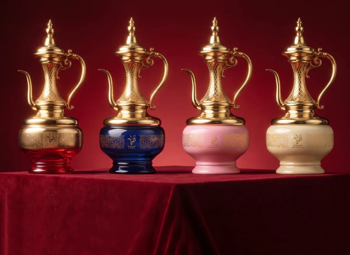 The four Dallah fragrances by Emper standing on red velvet: Esencia, Cuba, Turkish and Arabica